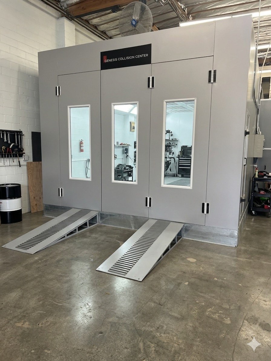 Professional paint booth with Genesis Collision Center branding
